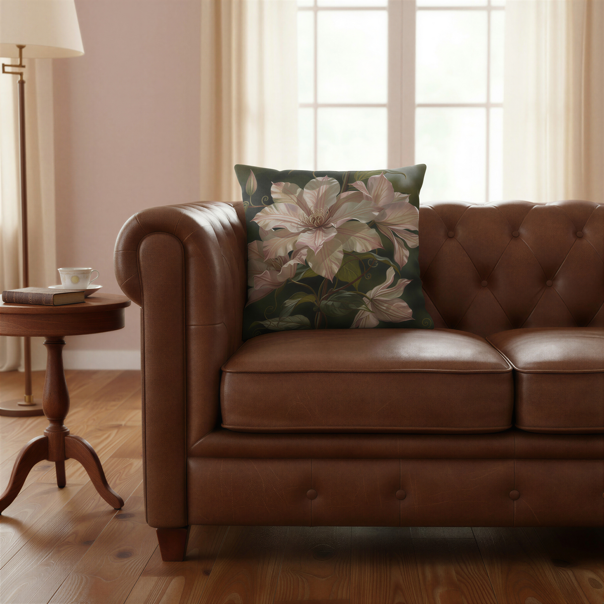 Floral scatter cushion displaying oversized soft pink clematis blossoms and curling botanical vines surrounded by dark green foliage.