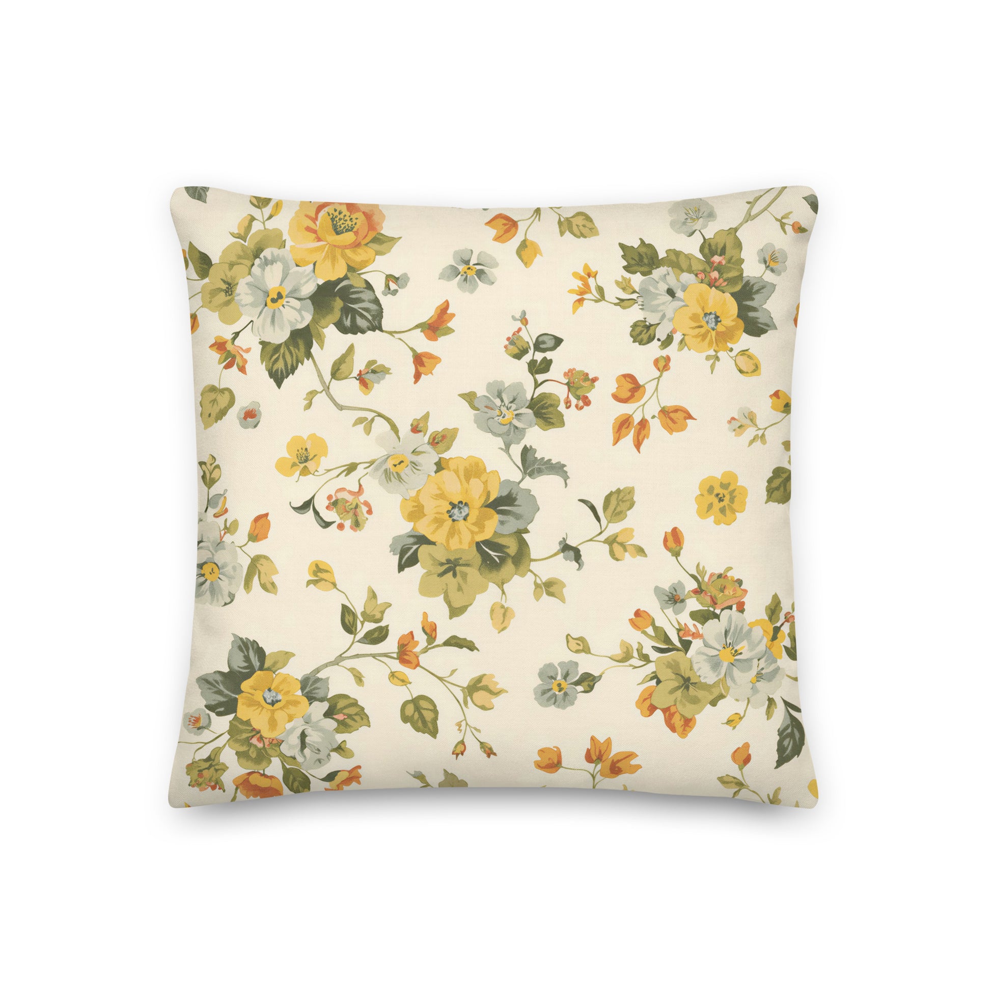 Square cushion displaying delicate botanical flowers and winding stems in muted yellow, cream, blue, green and orange tones. The pattern has a classic English country garden appearance.